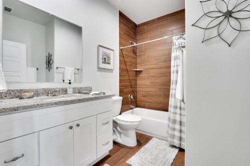 a bathroom with a sink and a toilet and a tub at Oasis by the Lake in Canyon Lake