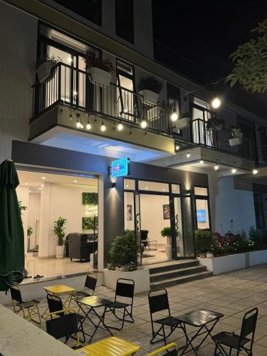 a patio with tables and chairs in front of a building at Liverpool House Mộc Châu in Mộc Châu