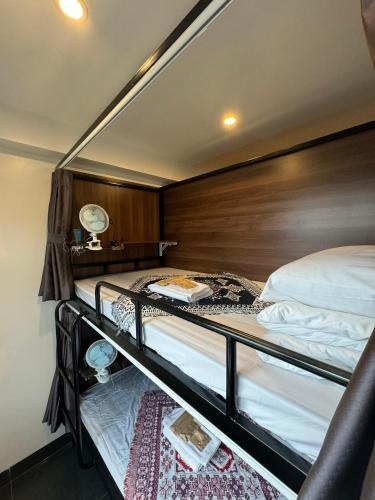 a bedroom with two bunk beds with a wooden headboard at Liverpool House Mộc Châu in Mộc Châu