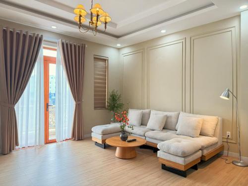 a living room with a couch and a table at Cole Hotel & Apartment in Ho Chi Minh City