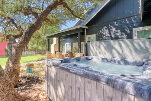 a hot tub in a backyard next to a house at Haydon House in Dripping Springs