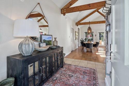 a living room with a table with a lamp on a dresser at Haydon House in Dripping Springs