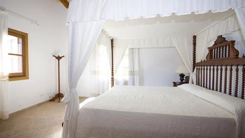 a bedroom with a white bed and a window at Finca Horlandis Ref 133 in Son Servera