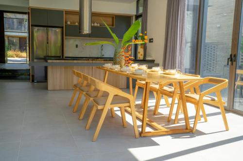 a wooden table and chairs in a kitchen at Coco villa in Hoi An