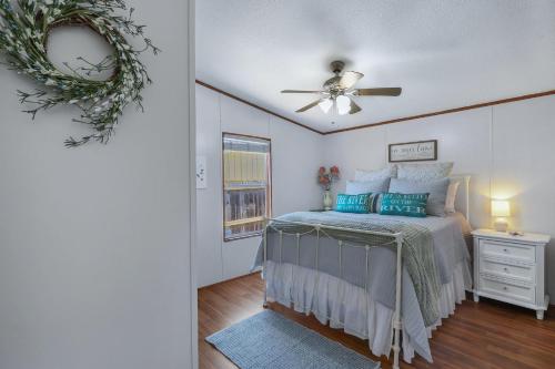 a bedroom with a bed and a ceiling fan at Howdy Hideaway in Wimberley