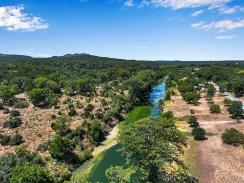 an aerial view of a river with trees at Howdy Hideaway in Wimberley