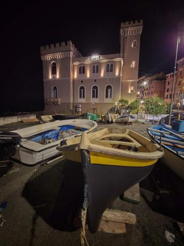 two boats are tied up in front of a building at Hotel Castello Miramare in Genova