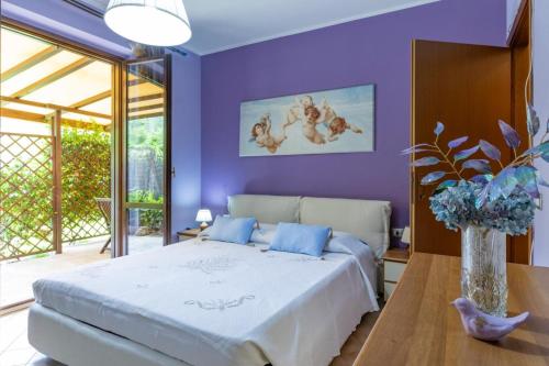 a purple bedroom with a bed and a table at Oasi del Mugello in Londa