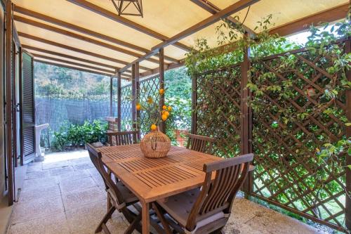 a patio with a wooden table and a fence at Oasi del Mugello in Londa