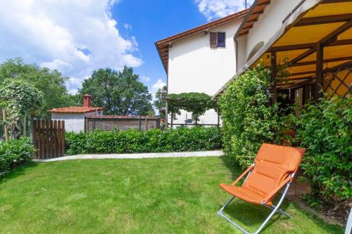 an orange chair sitting in the yard of a house at Oasi del Mugello in Londa