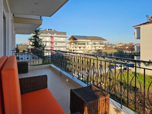 a balcony with an orange couch and a view at Dakis Luxury Apartments in Katerini
