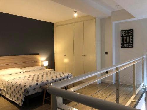 a small bedroom with a bed and a staircase at CriteriaHome! nice&easy in Madrid