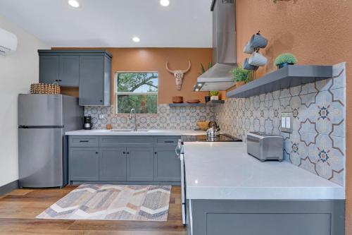 a kitchen with blue cabinets and a counter top at Martha at the Bend in Wimberley