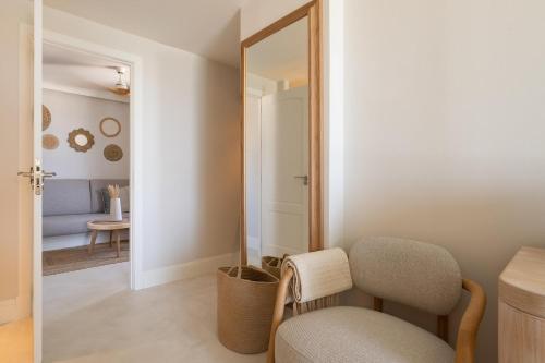 a room with a chair and a mirror at DAIA Slow Beach Hotel Conil - Adults Only Recommended in Conil de la Frontera