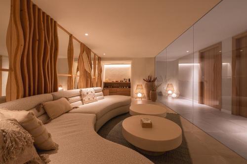 a living room with a couch and a table at DAIA Slow Beach Hotel Conil - Adults Only Recommended in Conil de la Frontera