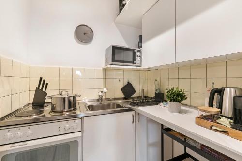 a kitchen with a sink and a stove top oven at Residenza Tasso Sul Lago - Happy Rentals in Ruvigliana