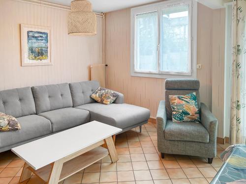 a living room with a couch and a chair at Maison familiale à 500m des plages avec jardin in Saint-Nazaire