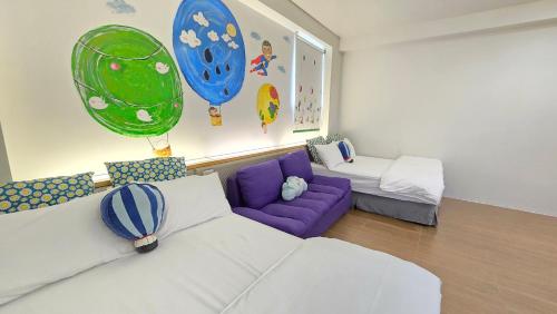 a living room with a white couch and a purple sofa at ChaoPingJia Fengge Guesthouse in Wujie