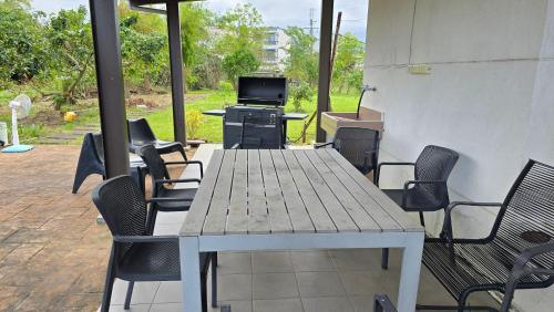 a table with chairs and a television on a patio at ChaoPingJia Fengge Guesthouse in Wujie
