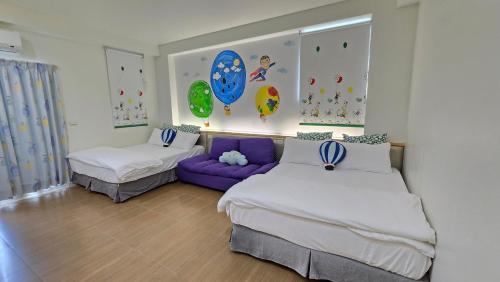a bedroom with two beds and a purple couch at ChaoPingJia Fengge Guesthouse in Wujie