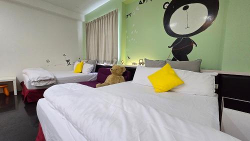 a bedroom with two beds with a teddy bear sitting on the bed at ChaoPingJia Fengge Guesthouse in Wujie