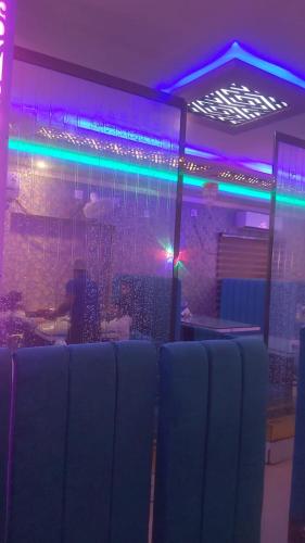 a room with purple and blue lights in a room at Hotel Hangout in Jangipur