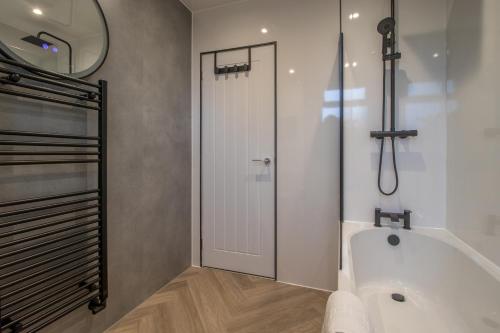a bathroom with a bath tub and a shower at Westlea House in Airdrie