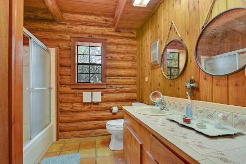 a bathroom with a toilet sink and a mirror at Rocky Mountain in New Braunfels