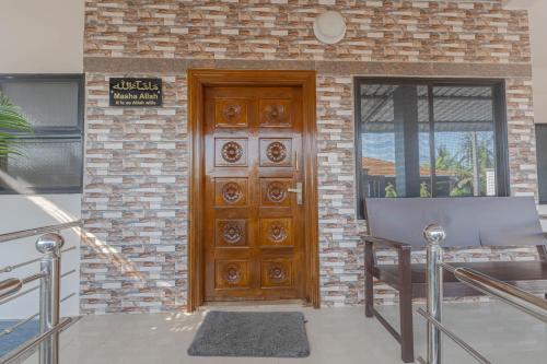 a wooden door in front of a brick building at UDUPI HOMESTAY - Hill Top Villa in Udupi