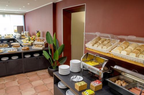 a buffet line with a bunch of pastries in a restaurant at Hotel Marc'Aurelio in Rome