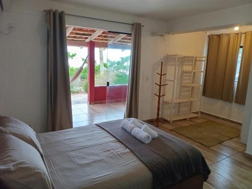 a bedroom with a bed with two pillows on it at Vila Penelope Guest House in Balneário Camboriú