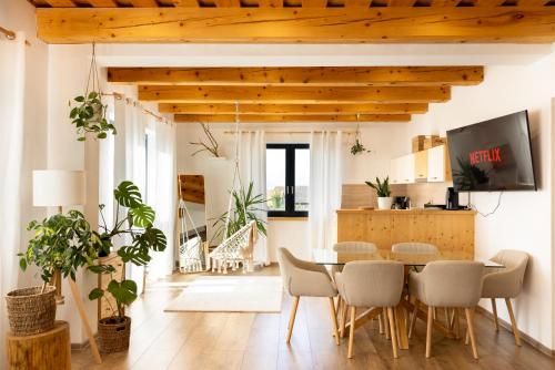 a kitchen and dining room with a table and chairs at Cool Mountain Escape - AC - Summer Cinema - 2BR Family Apartment - Garden - Liptov in Liptovská Kokava