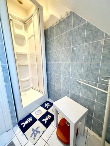 a small bathroom with a table and a shower at Maison de charme Terrasse 5min des plages in Port-Louis