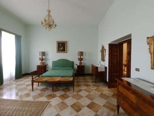 a living room with a green couch and a table at Villa Donna Anna in Assisi