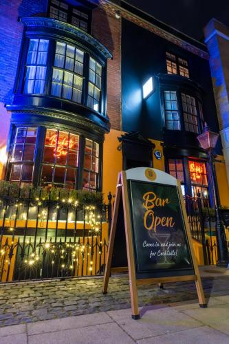 a sign in front of a building with a bar open at Becketts Townhouse in Portsmouth