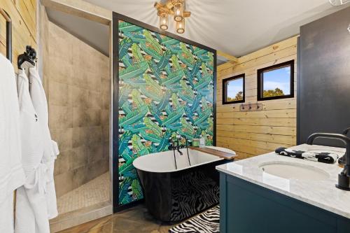 a bathroom with a shower and a tub and a sink at Mystic Hills Ranch in Fischer