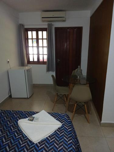 a room with a table and a table and a chair at Pousada do DIDI in Chapada dos Guimarães
