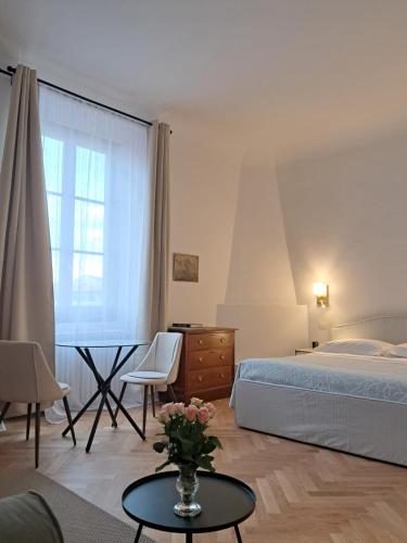 sypialnia z łóżkiem, stołem i krzesłami w obiekcie Palazzo Capponi alle Rovinate we Florencji