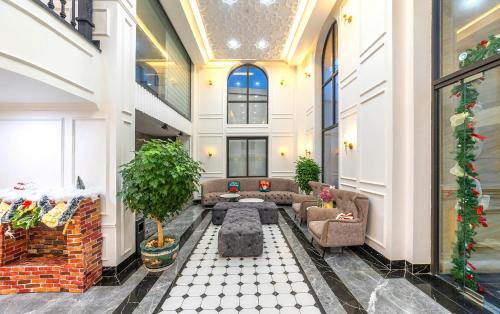 a lobby of a building with couches and plants at Green LP Hotel & Apartment in Vung Tau