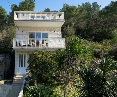 a house with a balcony on top of it at Il Mare - beach house in Blato