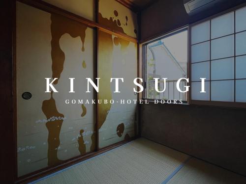 a room with a window with the words kittrust at Gomakubo in Osaka