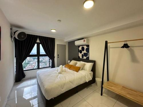 a bedroom with a large bed with a soccer ball on the wall at Arte Cheras The Premium Suites by iLuxHome in Kuala Lumpur