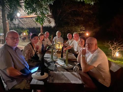 a group of people sitting around a table at Wild Wadi Wilpattu - Villas with private Plunge Pools in Wilpattu
