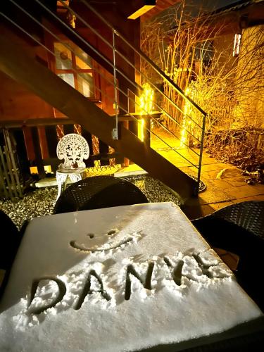 a sign written in the snow on a table at Landhaus de Gaspary in Seehausen am Staffelsee
