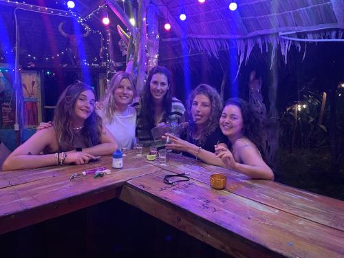 a group of women sitting at a table in a bar at Freedom home in Ko Chang