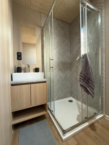 a bathroom with a shower and a sink at Mobile Home Aura, Village Twins in Pakoštane