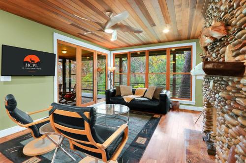 a living room with a couch and a ceiling fan at Cypress Star in Wimberley