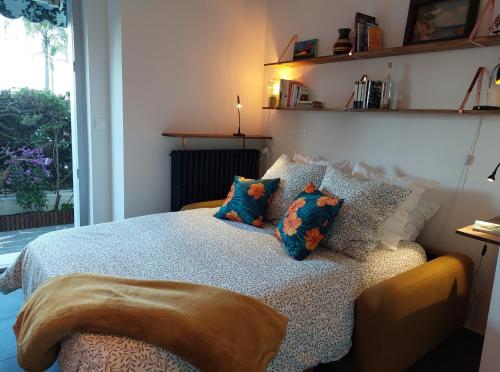 une chambre avec un lit avec des oreillers dessus dans l'établissement Grand studio avec terrasse à 20 m de la plage, à Nice