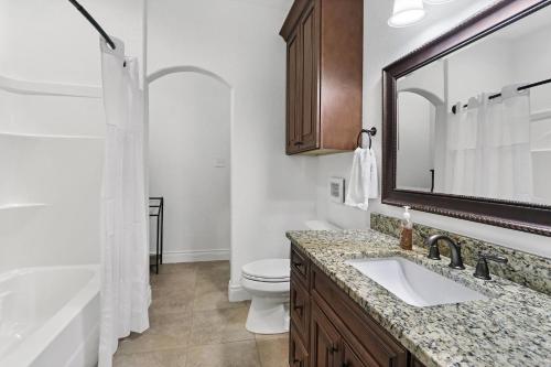 a bathroom with a sink and a toilet and a tub at Pampered Pillow in Canyon Lake