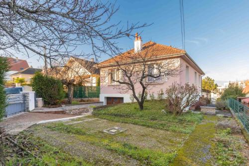 a small white house with a cross on the roof at Sweet Burgundy Villa in Dijon